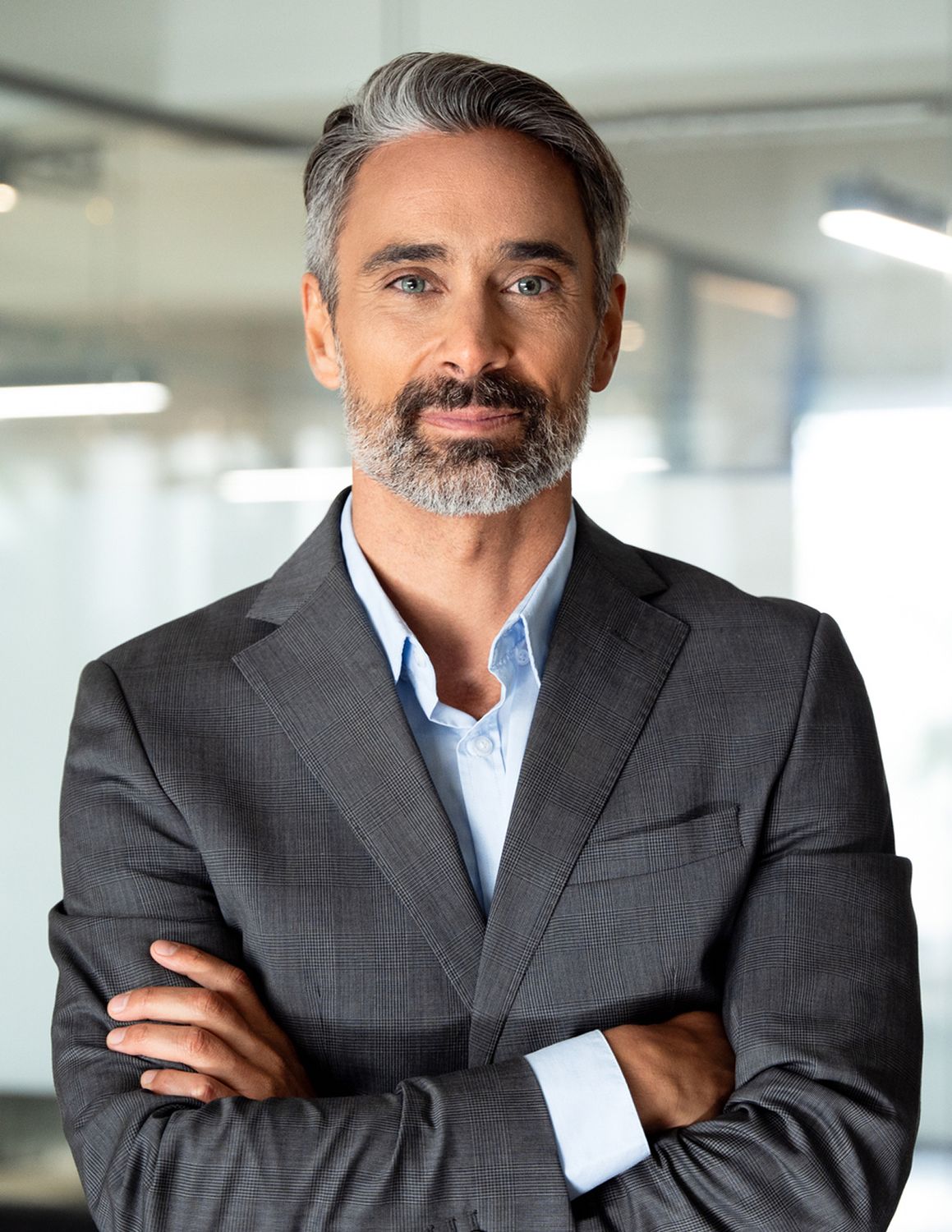 Confident man in a business suit, arms crossed.